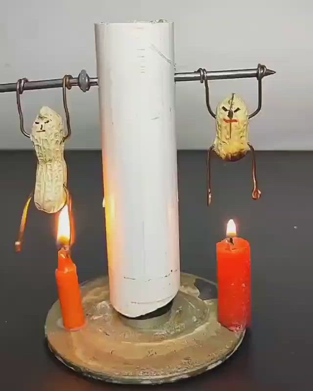 This may contain: two candles are sitting on a table with some decorations