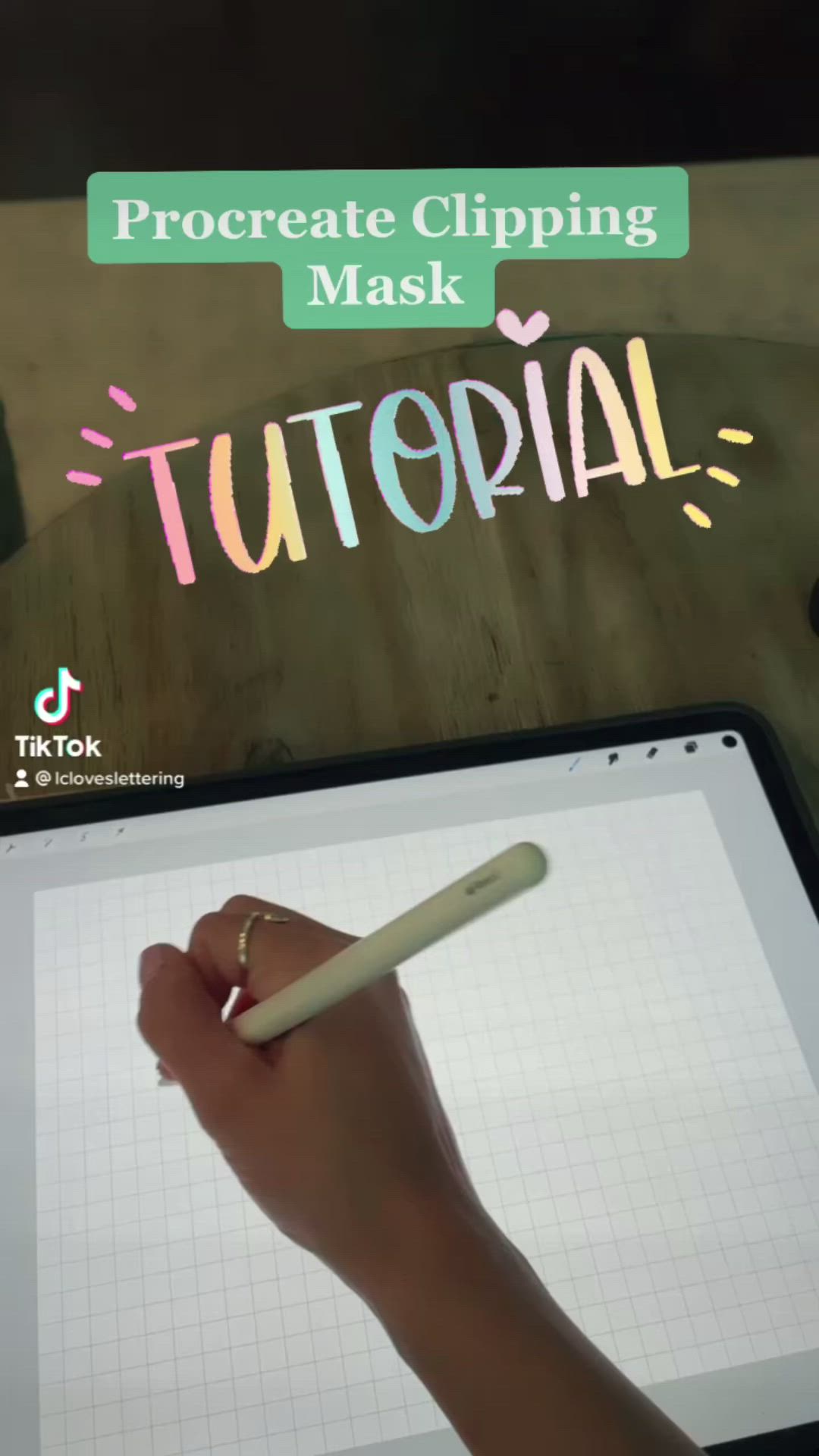 This may contain: a person holding a pen and writing on a tablet with the text procreate clipping mask