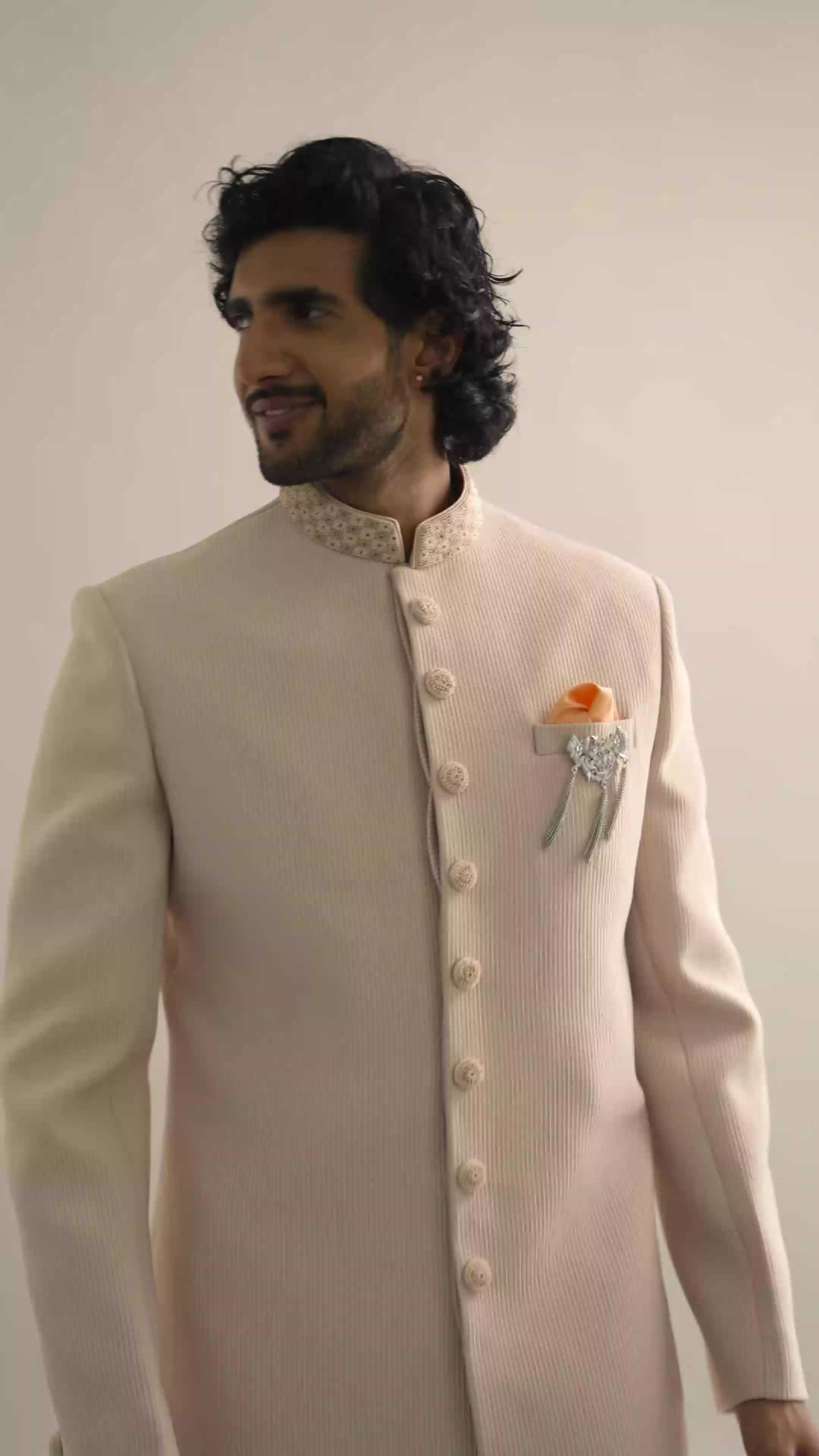 Indulge in this beige embroidered sherwani.
Crafted in polyester fabric, it is adorned with intricate beads and moti embroidered neckline.
Opt for this outfit at wedding occasions and sangeet functions.
This sherwani is paired with a bottom.