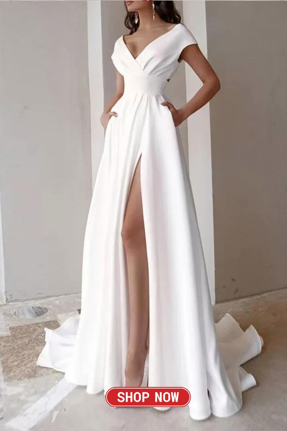 This may contain: a woman wearing a white dress with a slit in the side and one leg up