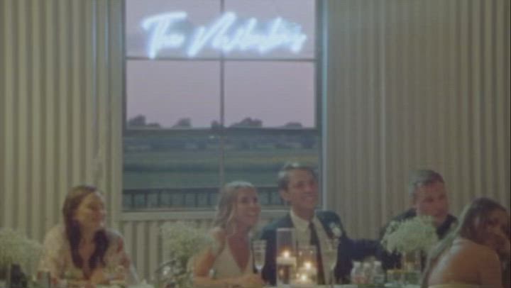 This may contain: a bride and groom kissing in a field