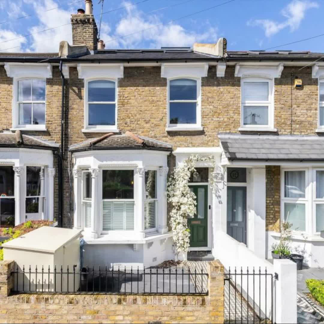 This may contain: a row of terraced houses with white windows