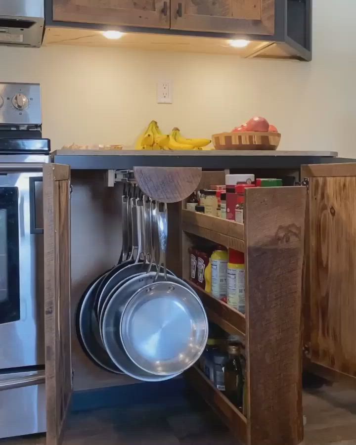 This may contain: a kitchen with pots and pans hanging from the ceiling, next to an oven