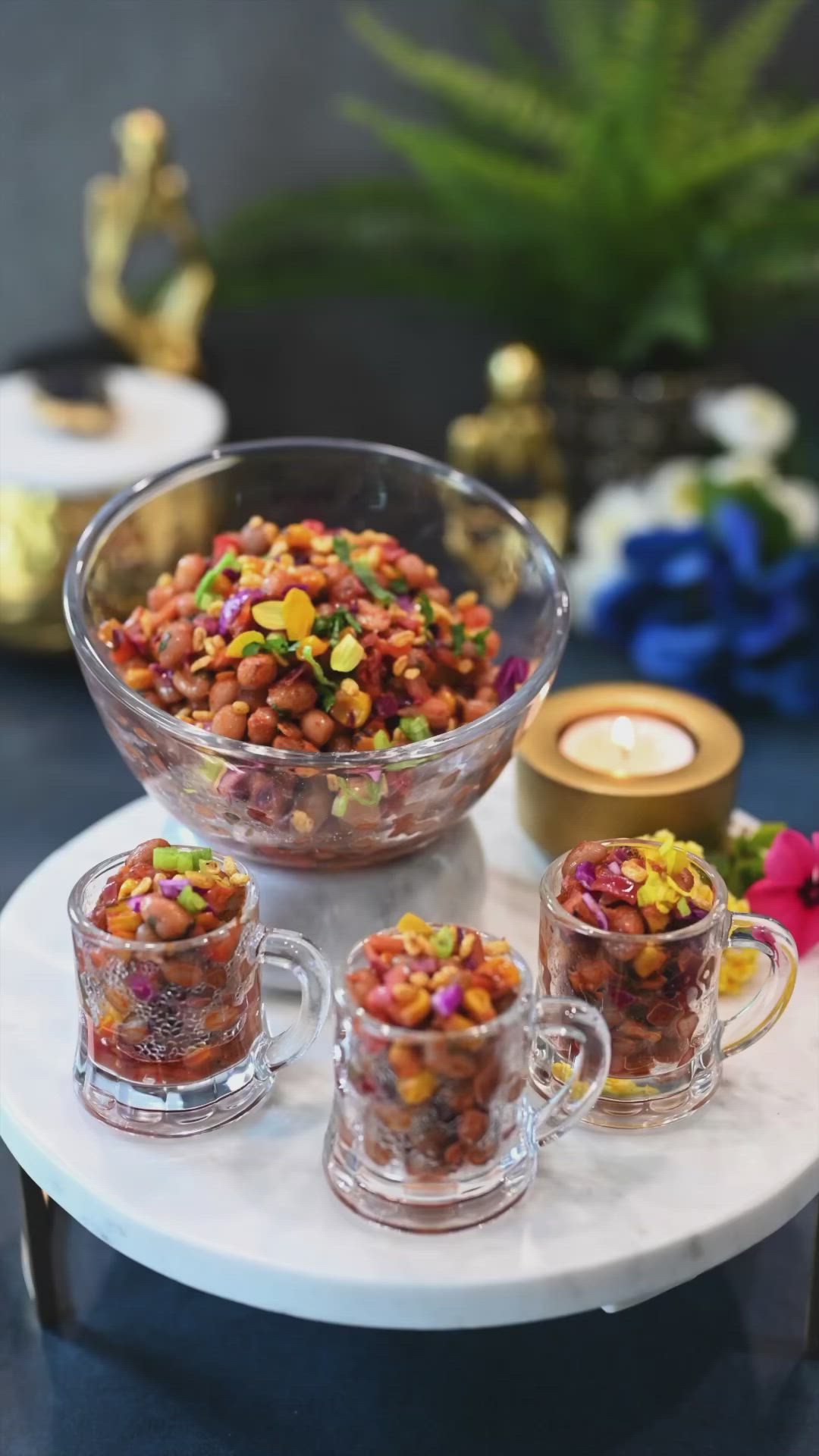 This may contain: a bowl filled with lots of different colored beans on top of a white table next to candles