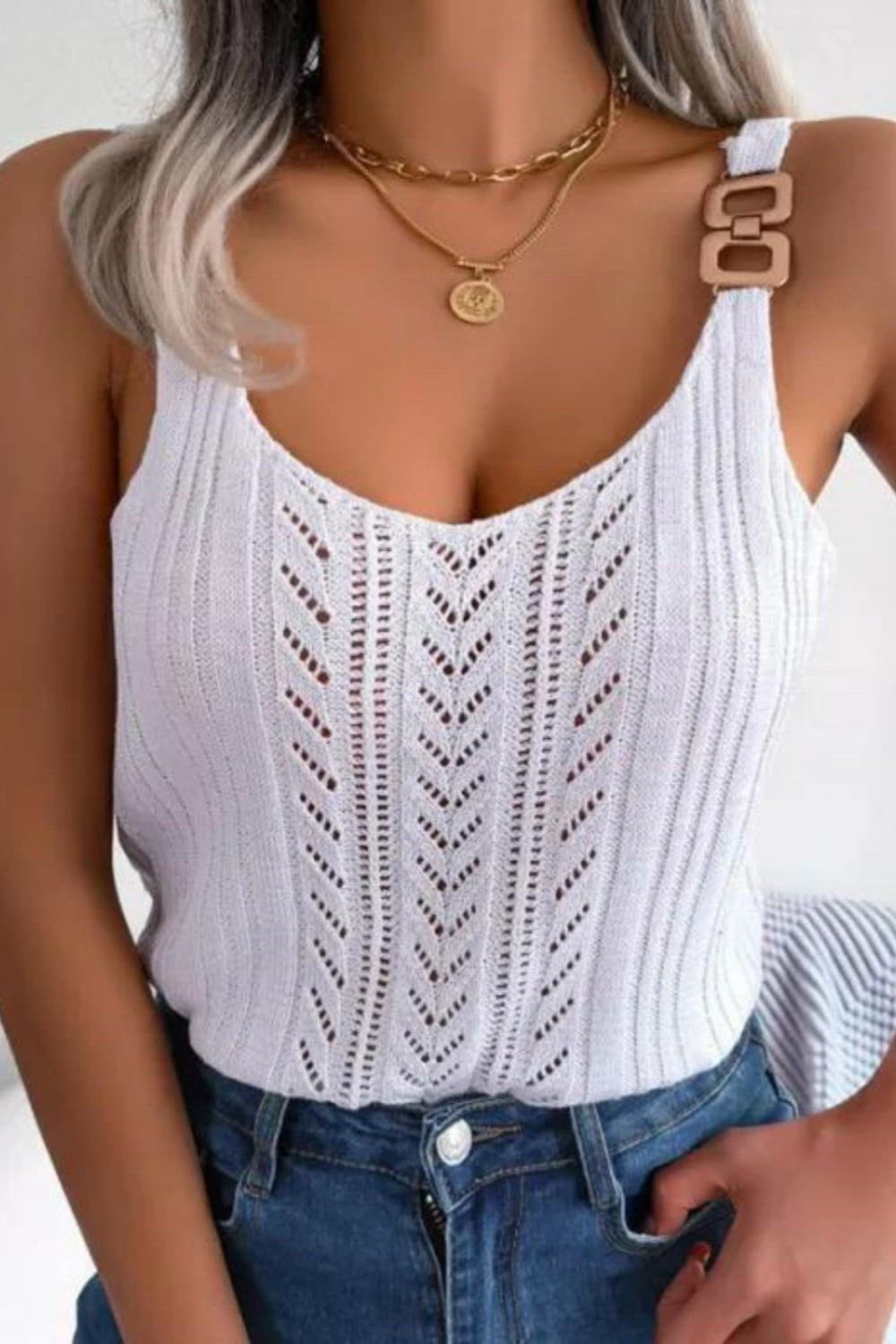 This knitted fashion vest features a stylish V-neck with metal button accents, exuding casual charm. Its intricate hollow design adds a touch of elegance to any outfit, making it a versatile choice for women seeking a trendy and comfortable look.