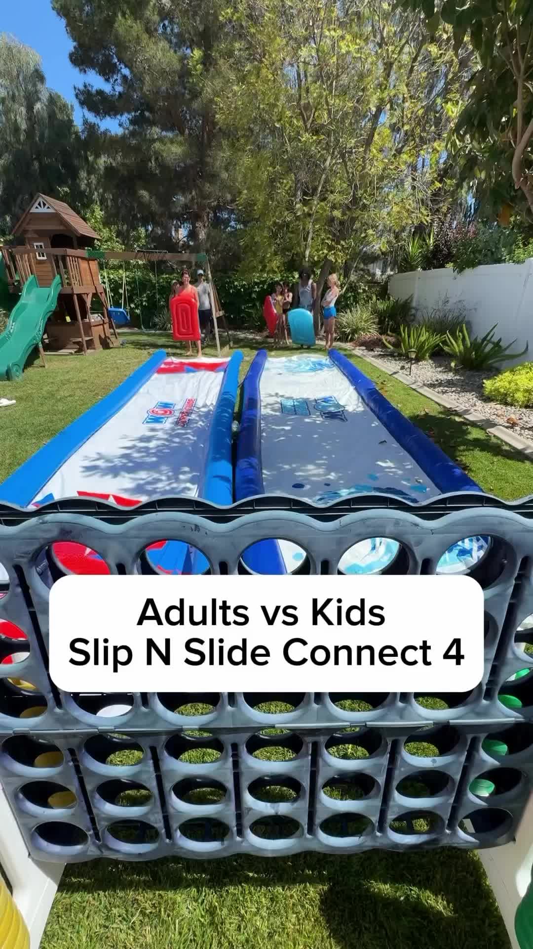 This may contain: an inflatable trampoline with the words adults vs kids slip n slide connect 4