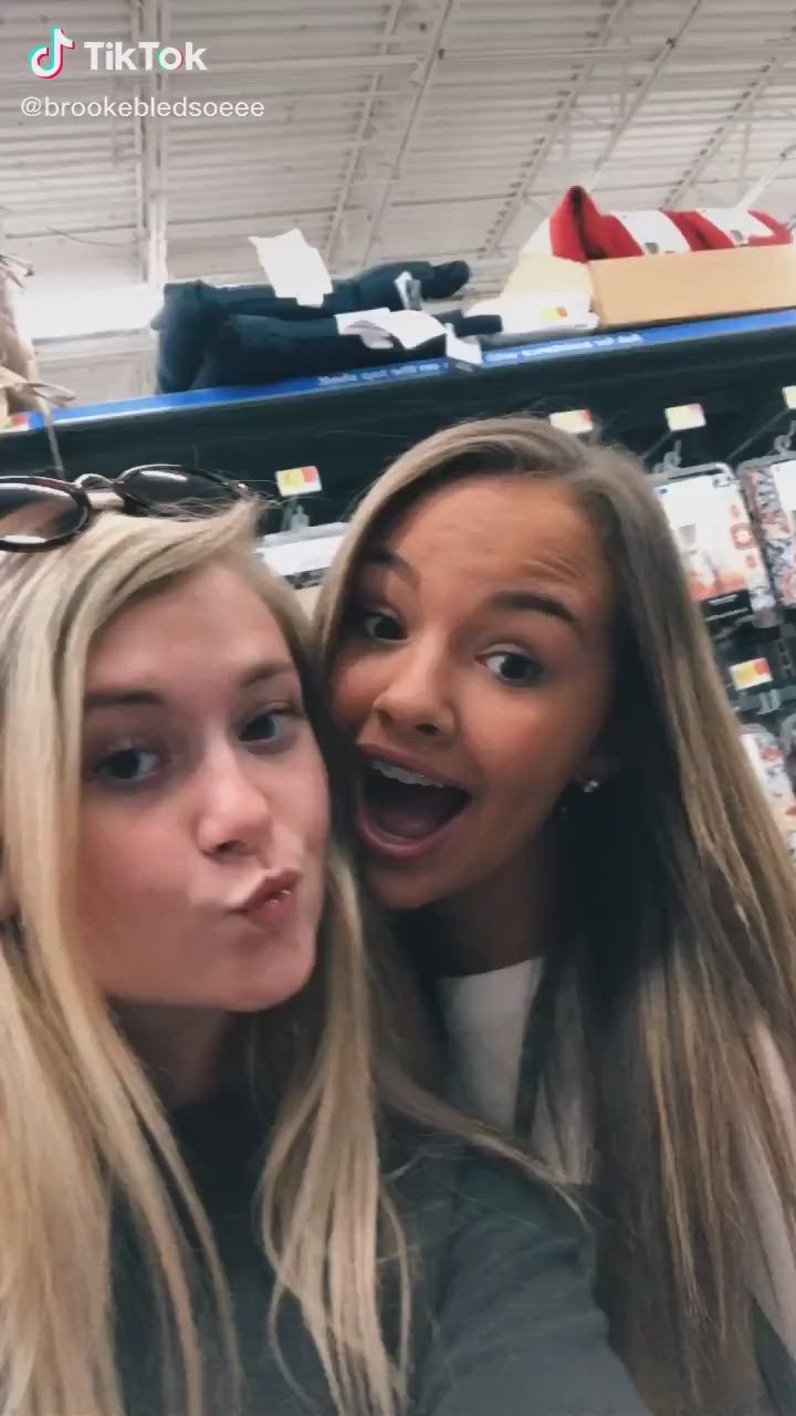 This may contain: two women are posing for the camera in a store