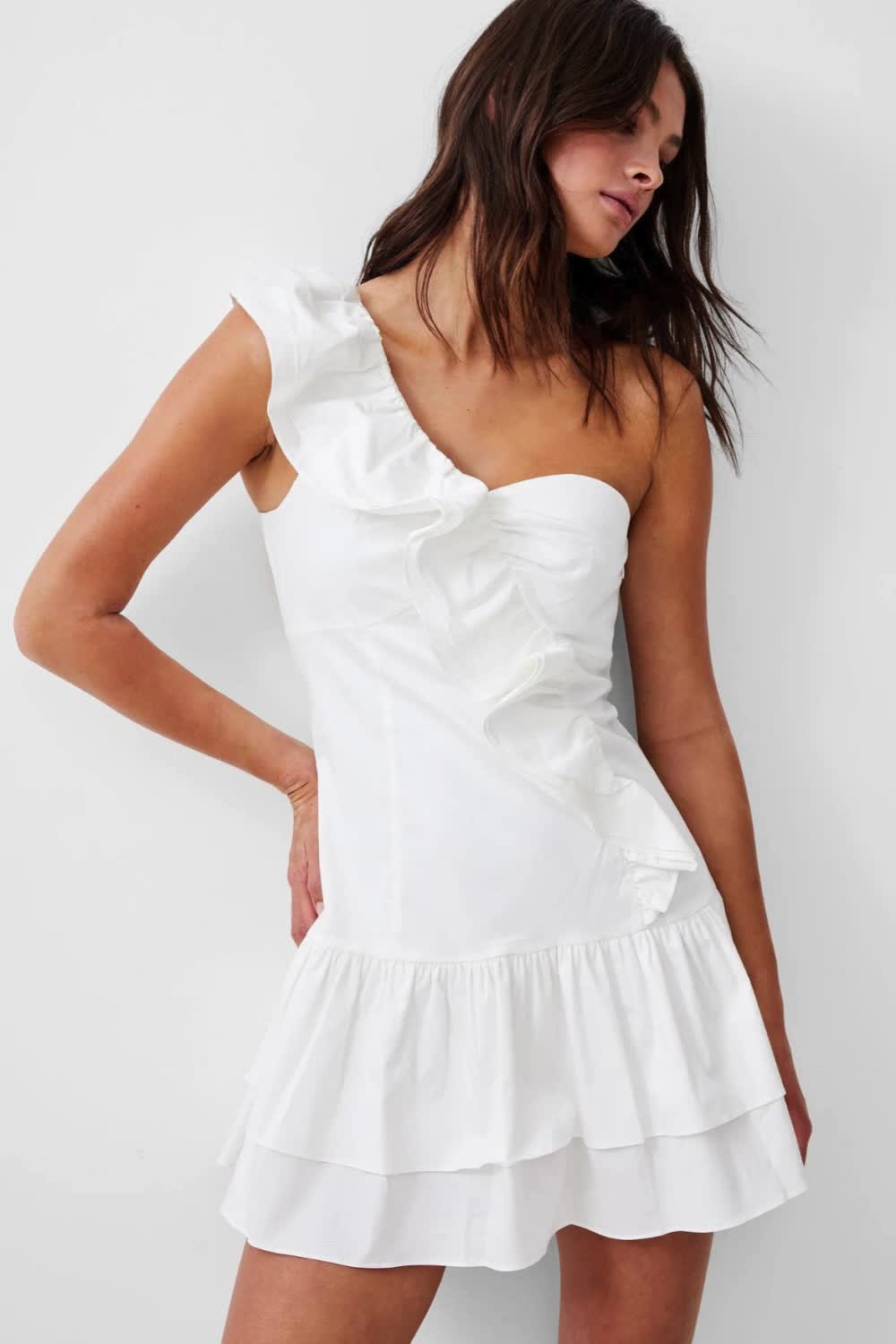 This contains: A woman wearing a white sleeveless ruffle dress