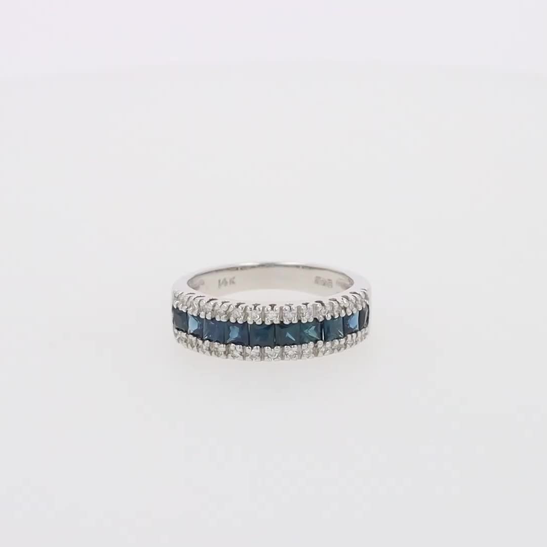 This may contain: a white gold ring with blue and white diamonds