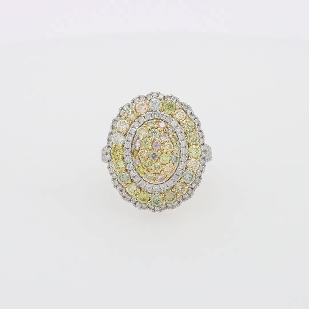 This may contain: a yellow and white diamond ring sitting on top of a table