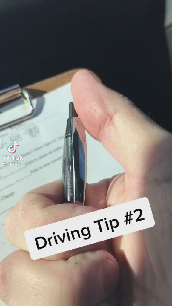 This may contain: a person holding a pen in their left hand with the words driving tip 2 written on it