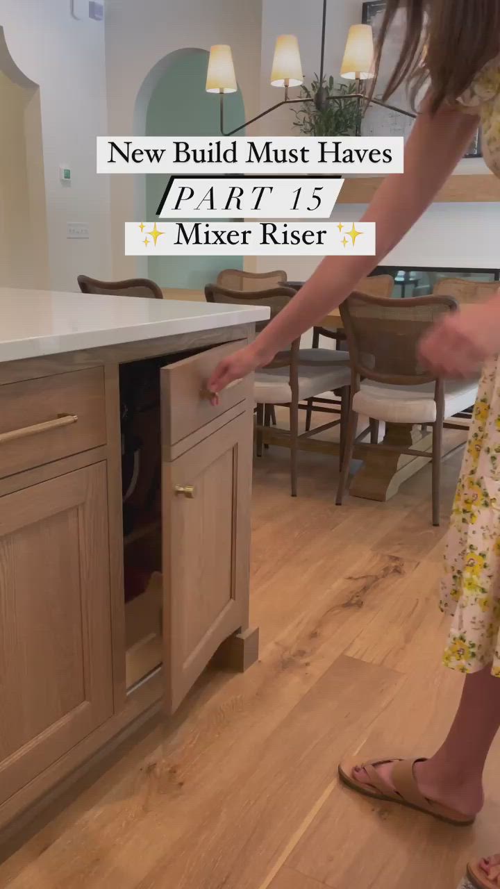 This may contain: a woman is using a mixer to pull out the cabinet from her kitchen counter top