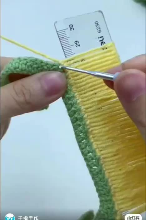 This may contain: someone is crocheting the end of a piece of yarn