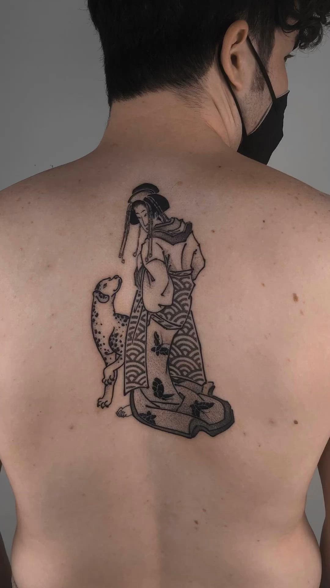 This may contain: a woman with a dog on the back of her body is depicted in this tattoo design