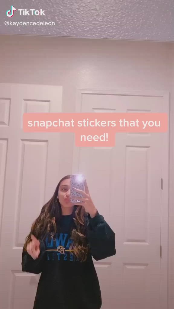 This may contain: a woman taking a selfie in front of a mirror with the caption snapchat stickers that you need