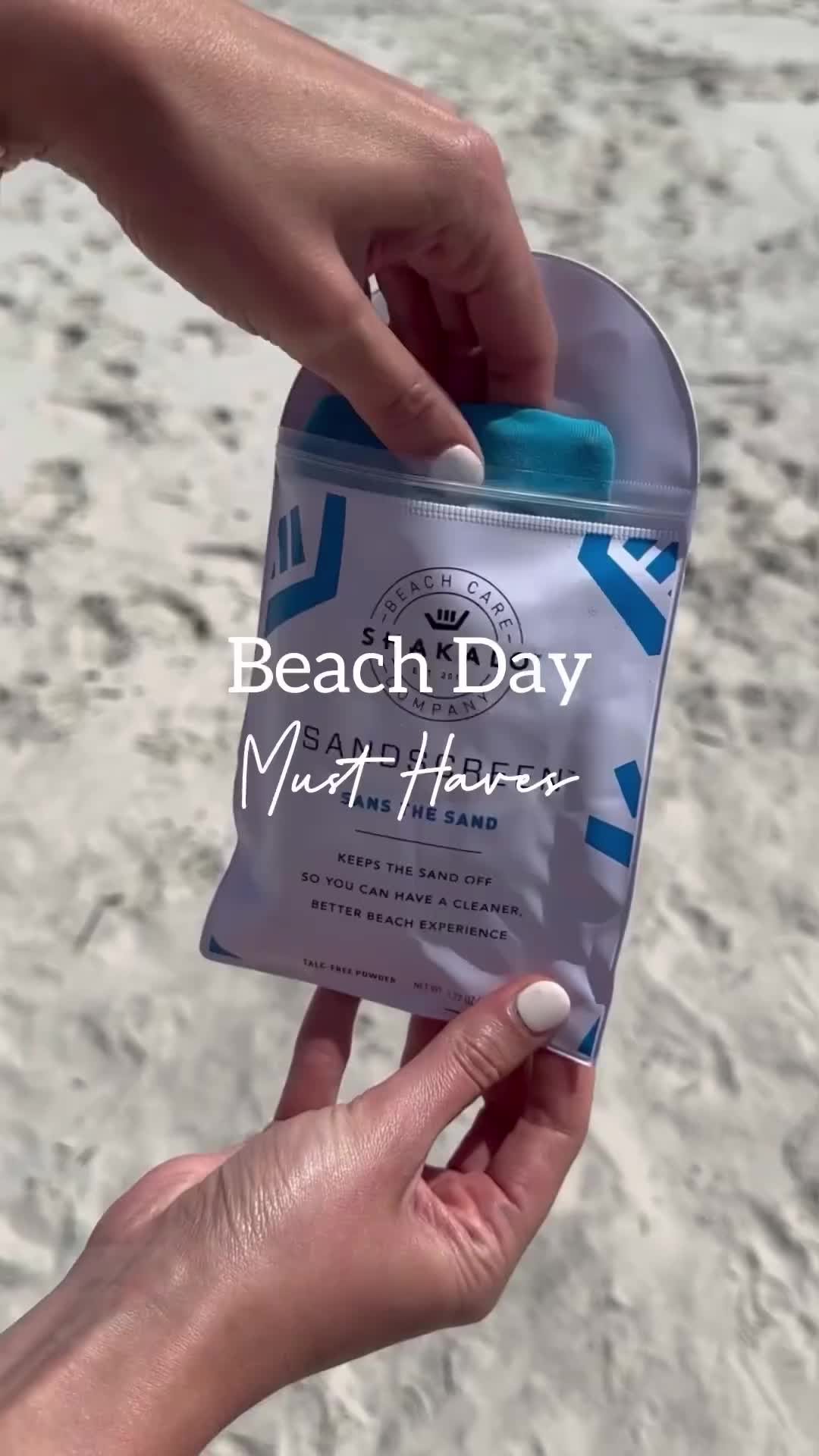 This may contain: someone is holding a beach day soap on the beach