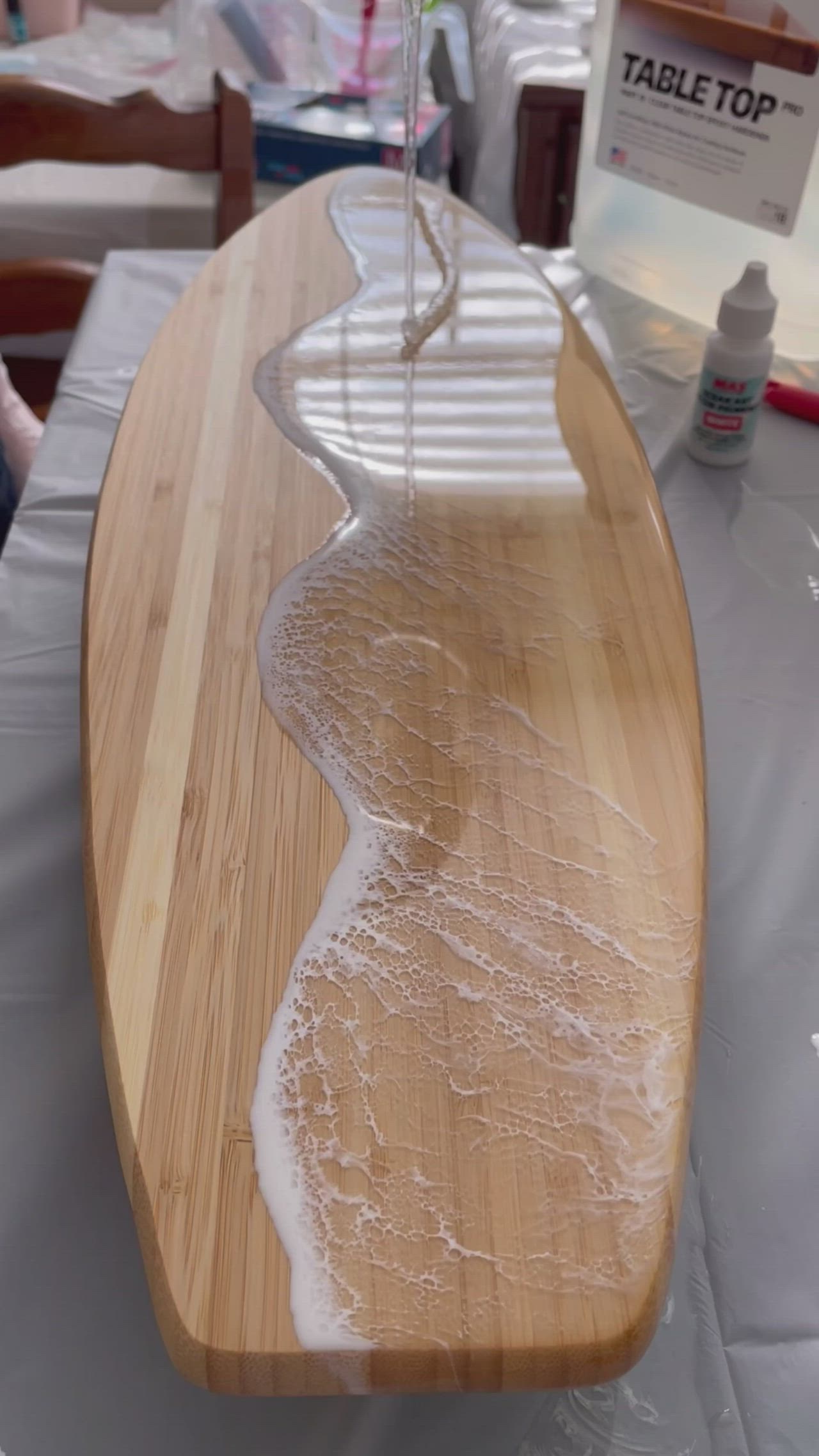 This may contain: the surfboard is being sanded down on the table