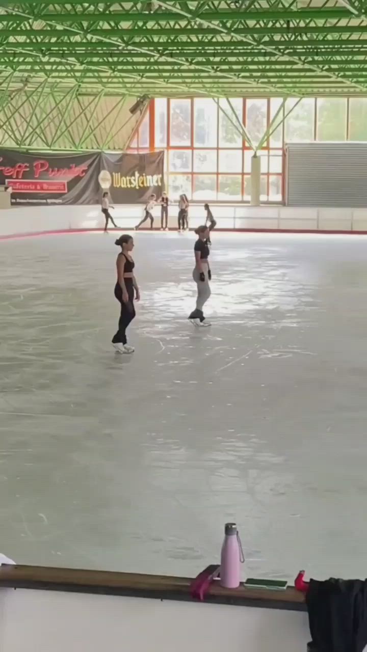 This may contain: some people are skating on an ice rink