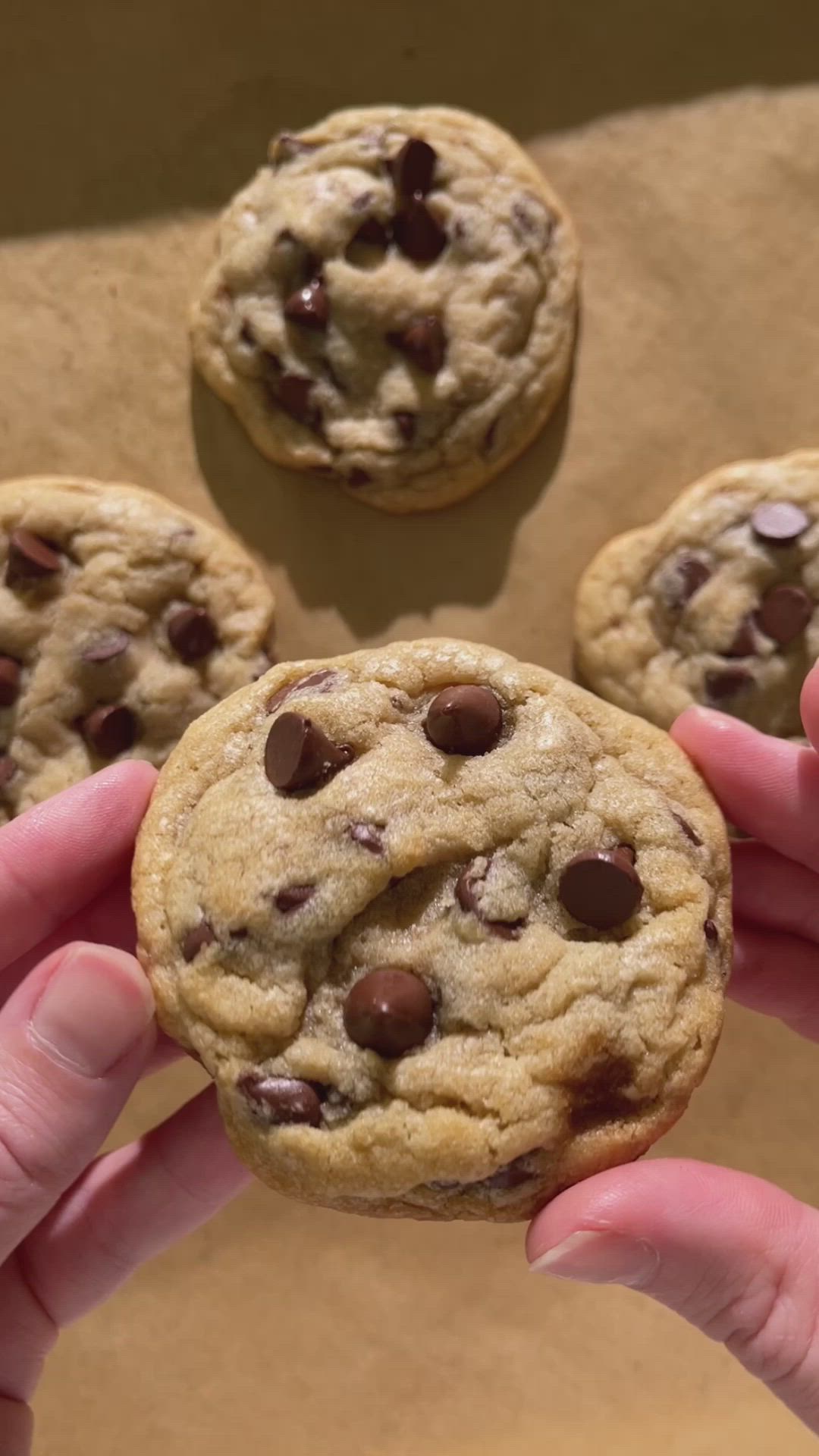 This may contain: two chocolate chip cookies sitting on top of each other