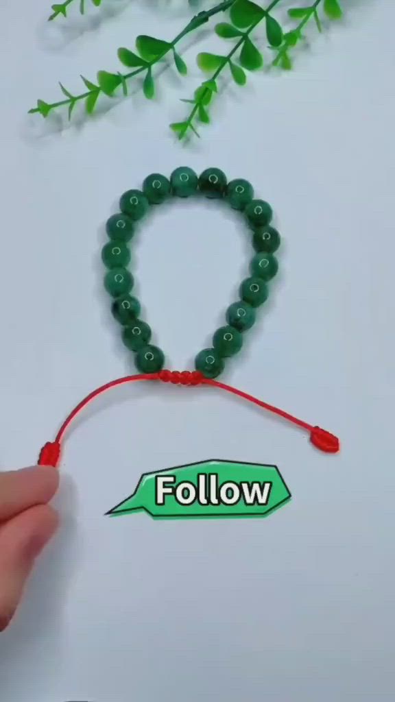 This may contain: a person holding a string with beads on it and the word follow written in green