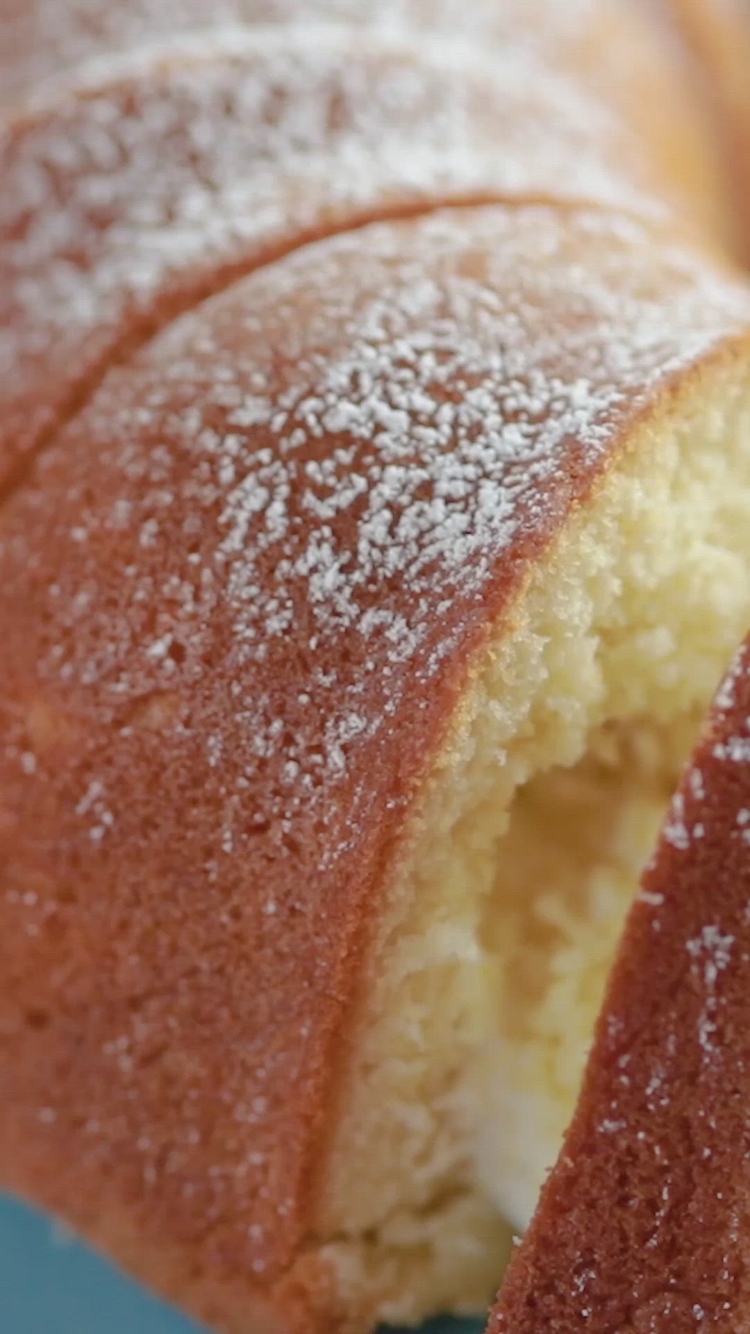 This may contain: a close up of a piece of cake on a plate with the words twinkie bundt cake