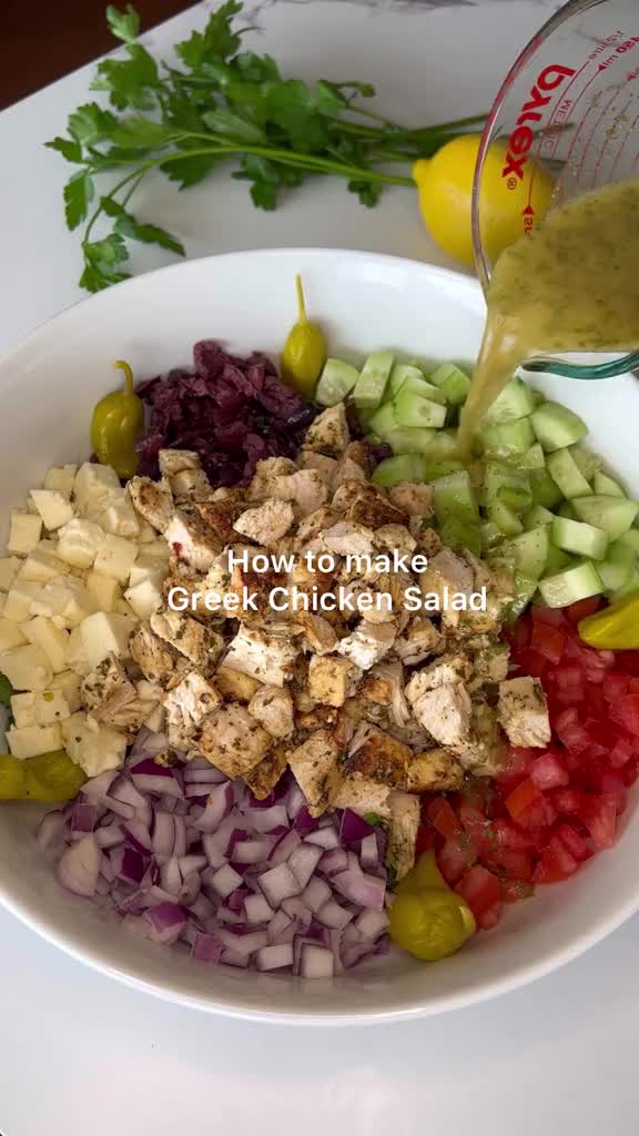 This contains: Authentic Greek Salad Recipe with fresh vegetables, feta cheese, and zesty dressing - My Big Fat Greek Salad 🥗