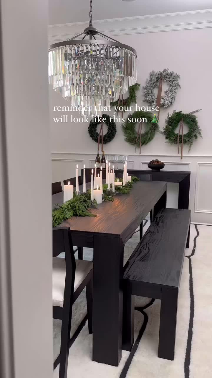 This may contain: a dining room table with chairs and a christmas tree in the corner next to it