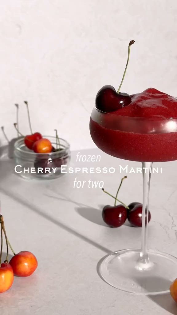 This may contain: cherry espresso martini for two with cherries on the rim