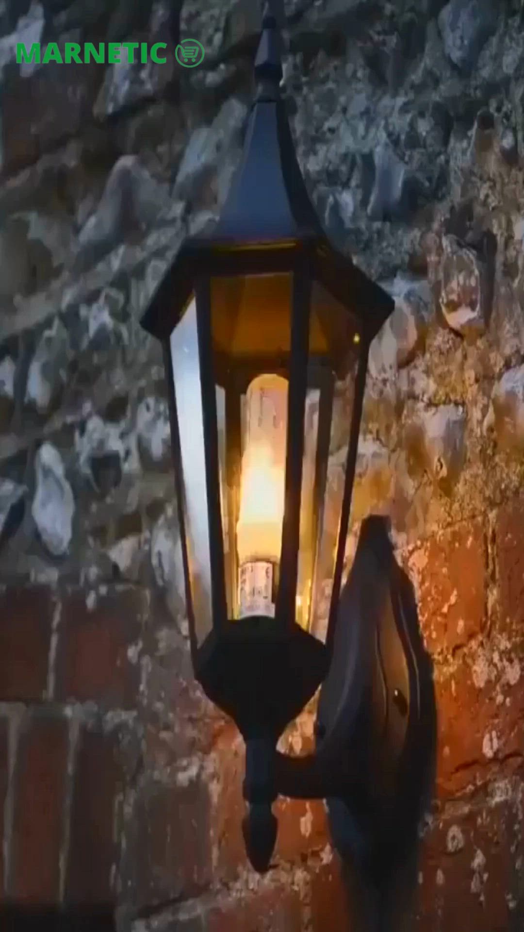 This may contain: a light that is on the side of a brick wall next to a stone wall