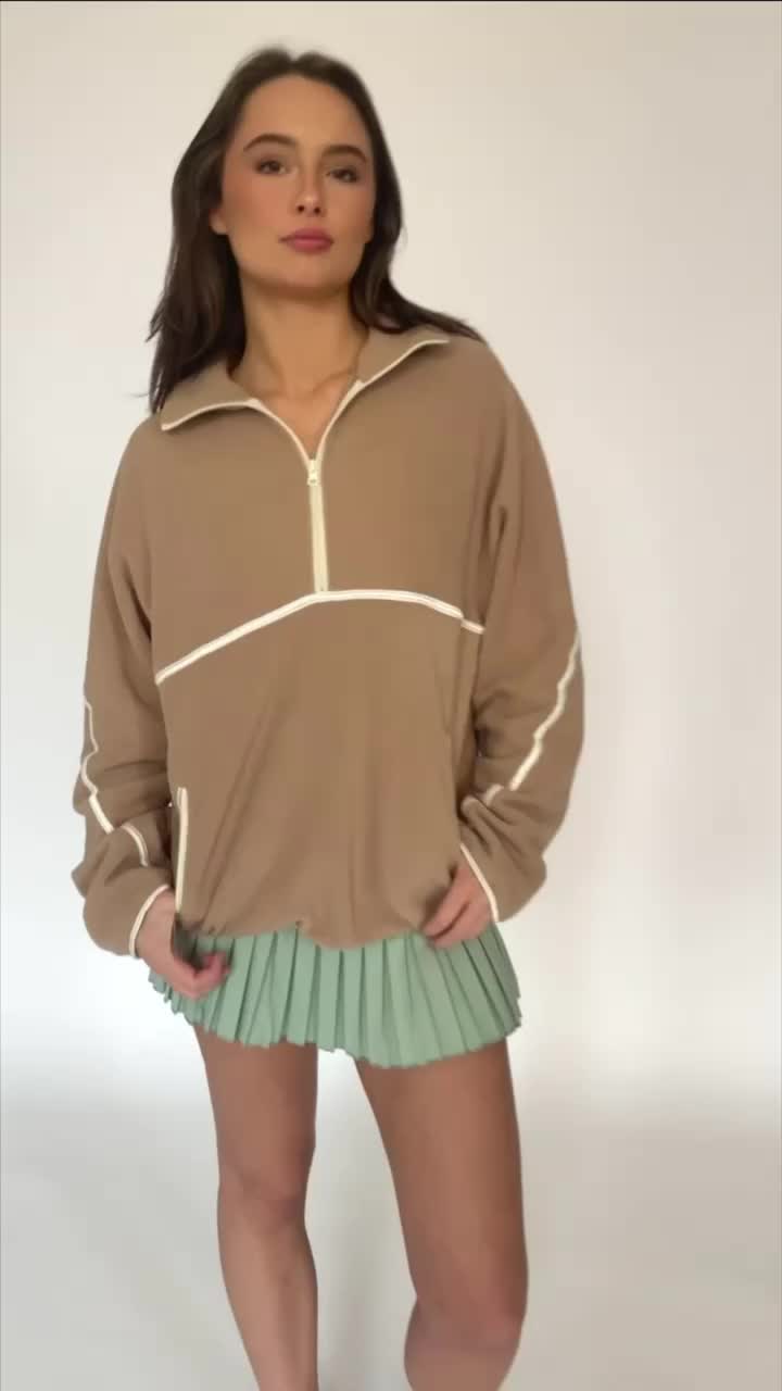 Beige Minimalistic Half-Zip Pullover is an absolute game changing staple you will find yourself living in. It has a trendy, minimalistic vibe with its beige color and cream line details. It features dual side pockets, half-zip closure and a soft, fleece material that is so warm. The fit is slightly oversized too, which is amazing.