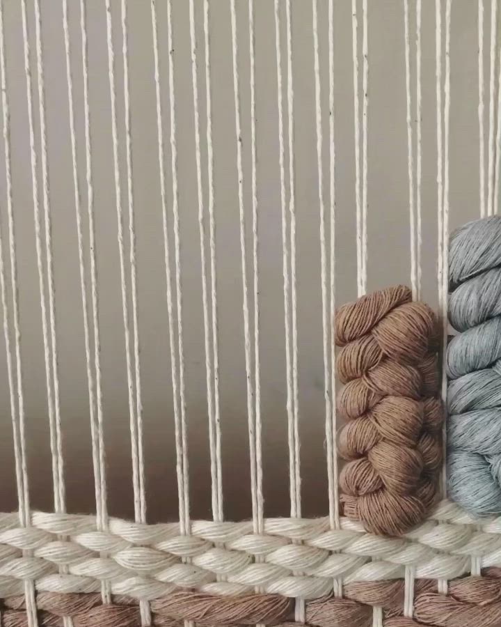 This may contain: three skeins of yarn sitting on top of a basket