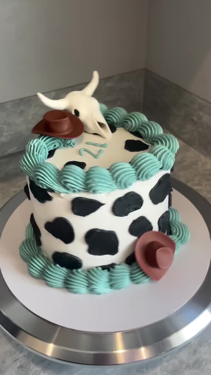 This may contain: an image of a cow on top of a cake that is made to look like it's coming out of the desert