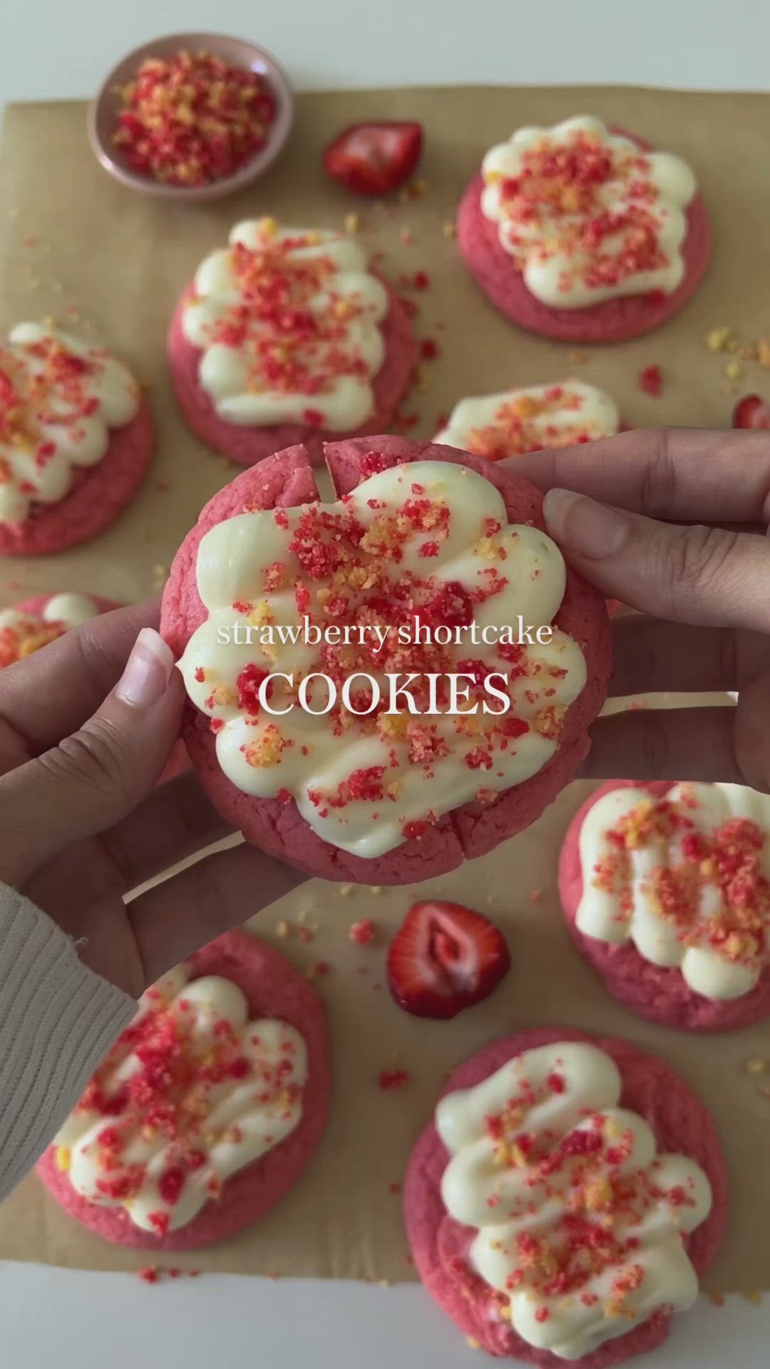 This may contain: strawberry shortbread cookies with white frosting and sprinkles