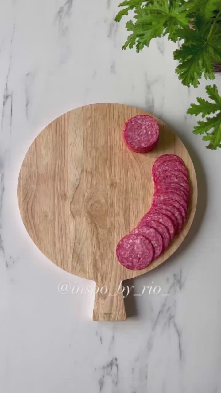 This may contain: a wooden cutting board with flowers on it