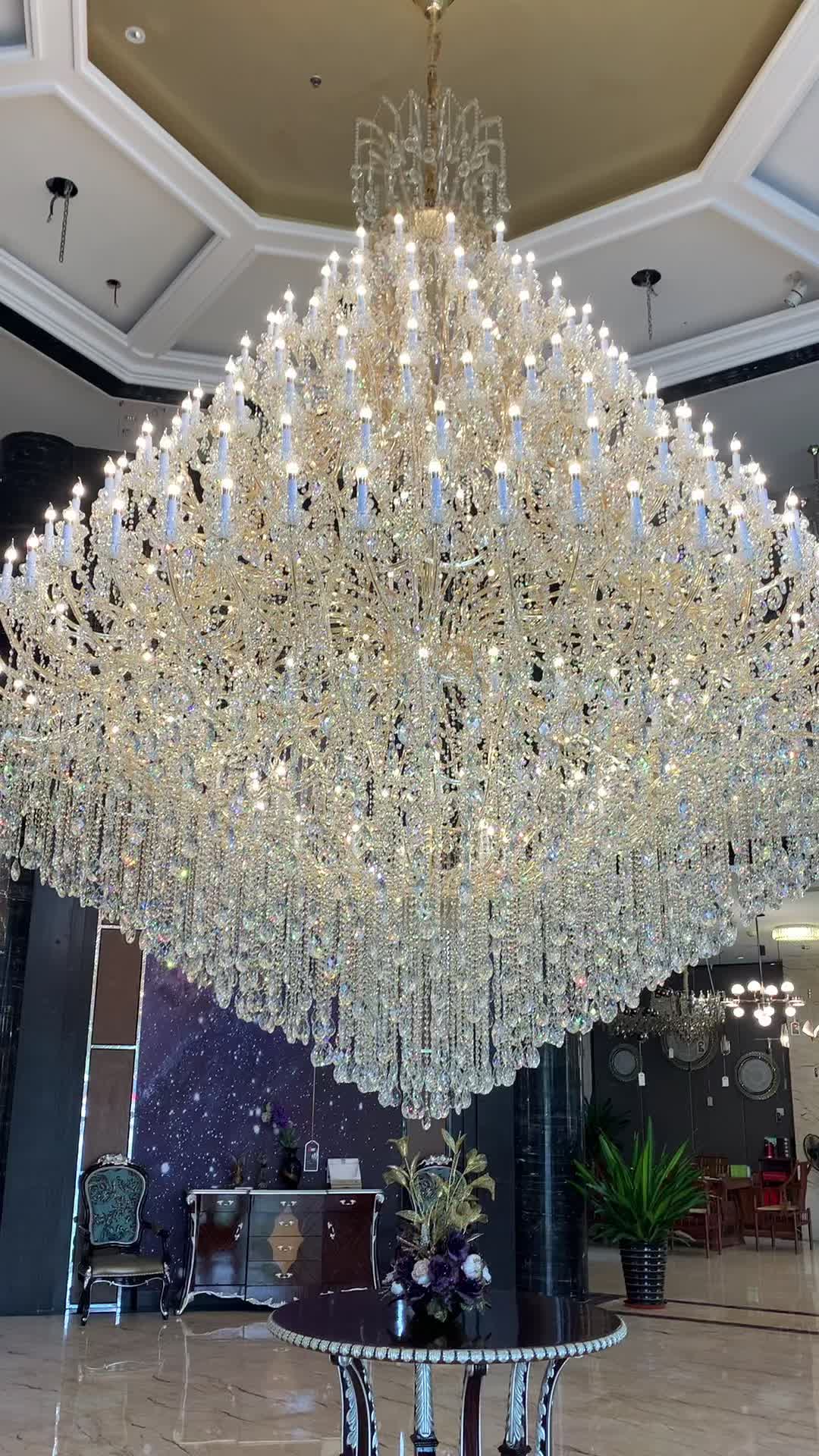 This may contain: a large crystal chandelier hanging from the ceiling in a hotel lobby with marble flooring