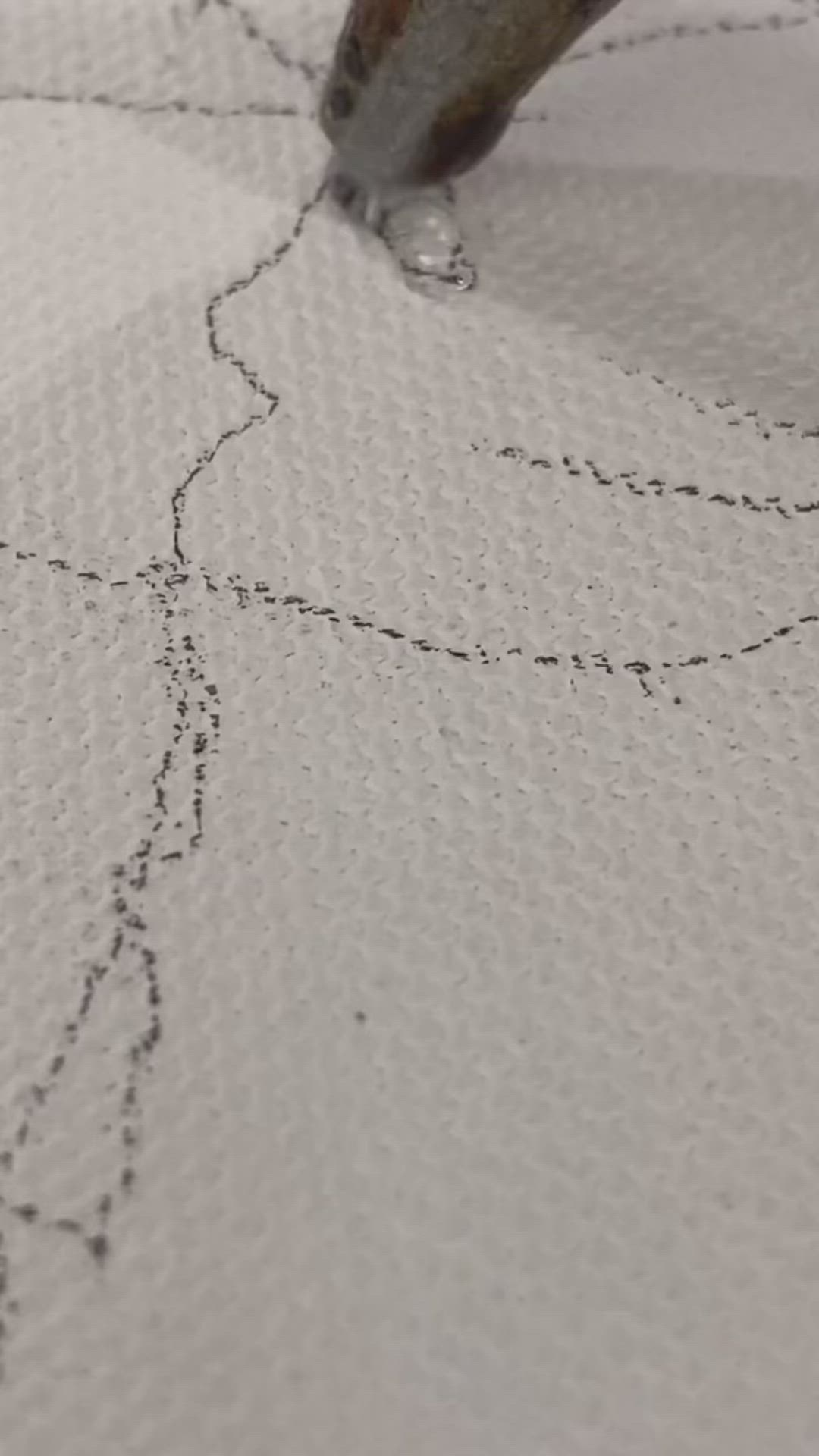 This may contain: a close up of a piece of cloth with stitching on it and a needle in the middle