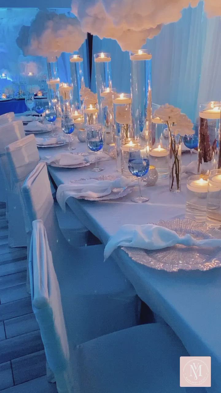 This may contain: a long table is set with candles and place settings for an event or special occasion