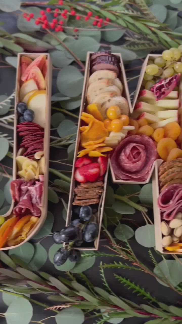 This may contain: a close up of two wooden boxes filled with fruit and veggie trays