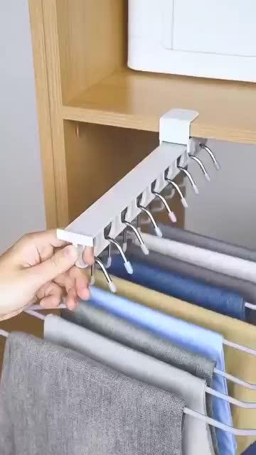 This contains: Intelligent pull-out slide trouser rack: a new solution for space utilization in the closet