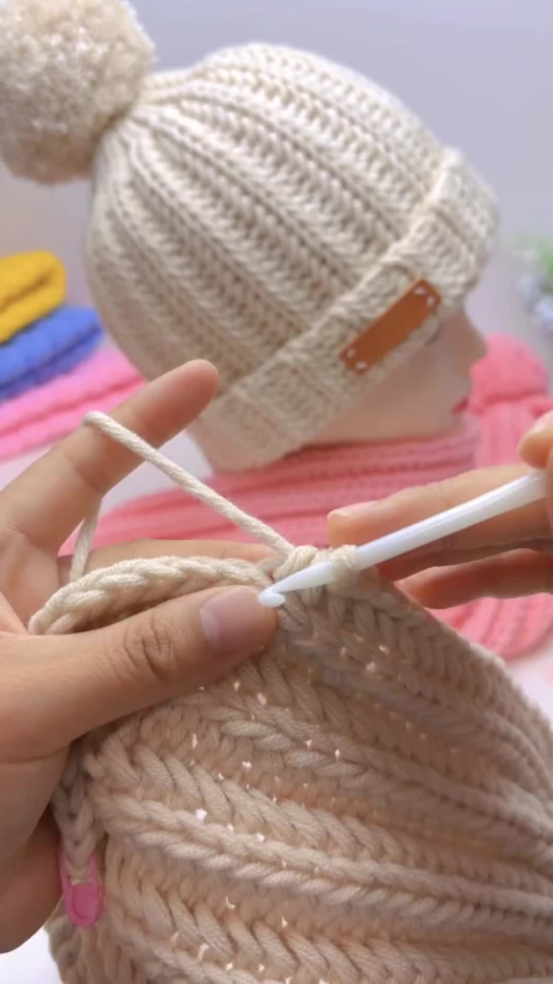 This may contain: someone is knitting yarn on top of a mannequin's head