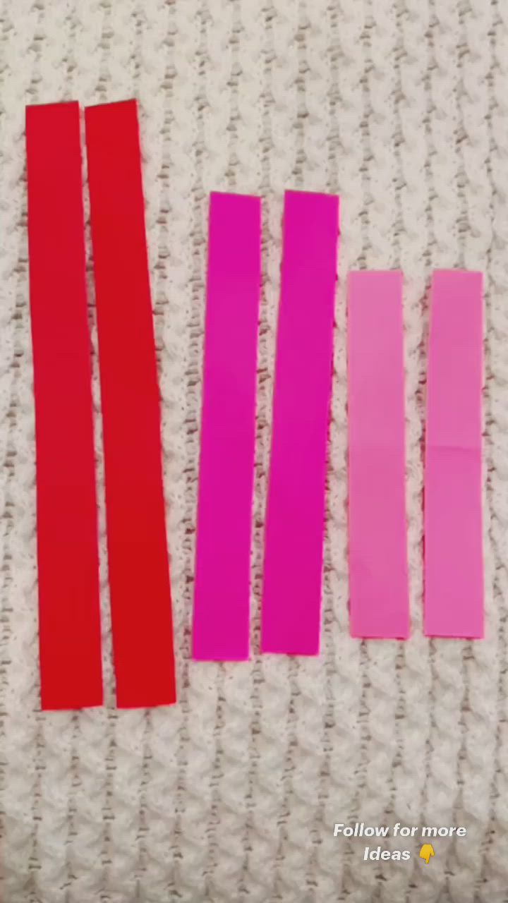 This may contain: four pieces of pink and red tape sitting on top of a white surface next to each other