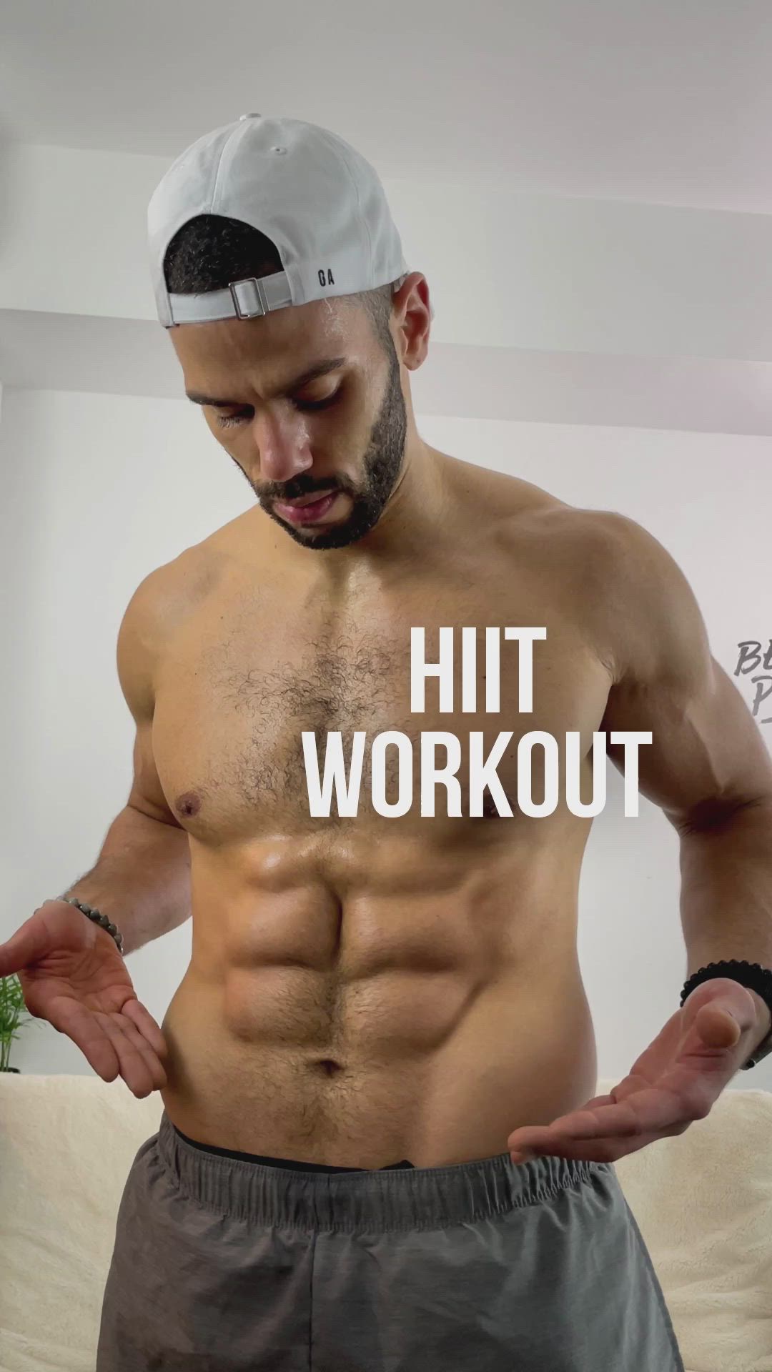 This may contain: a shirtless man with his hands on his hips and the words hit workout above him