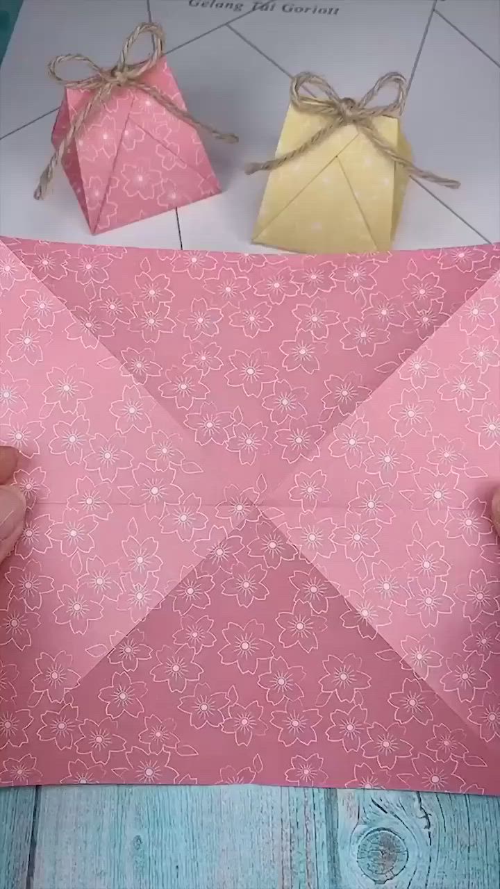 This may contain: someone is making a paper origami star