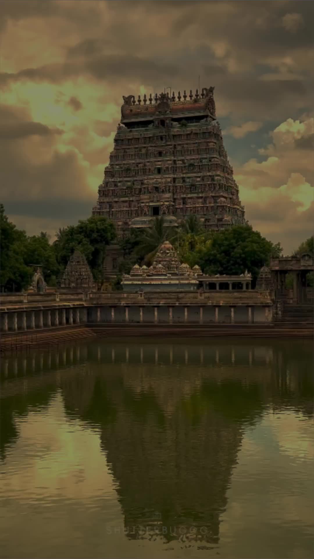 This may contain: a very tall building sitting on top of a lake