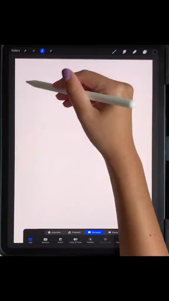 This may contain: a hand holding a pencil in front of a computer screen with an image on it