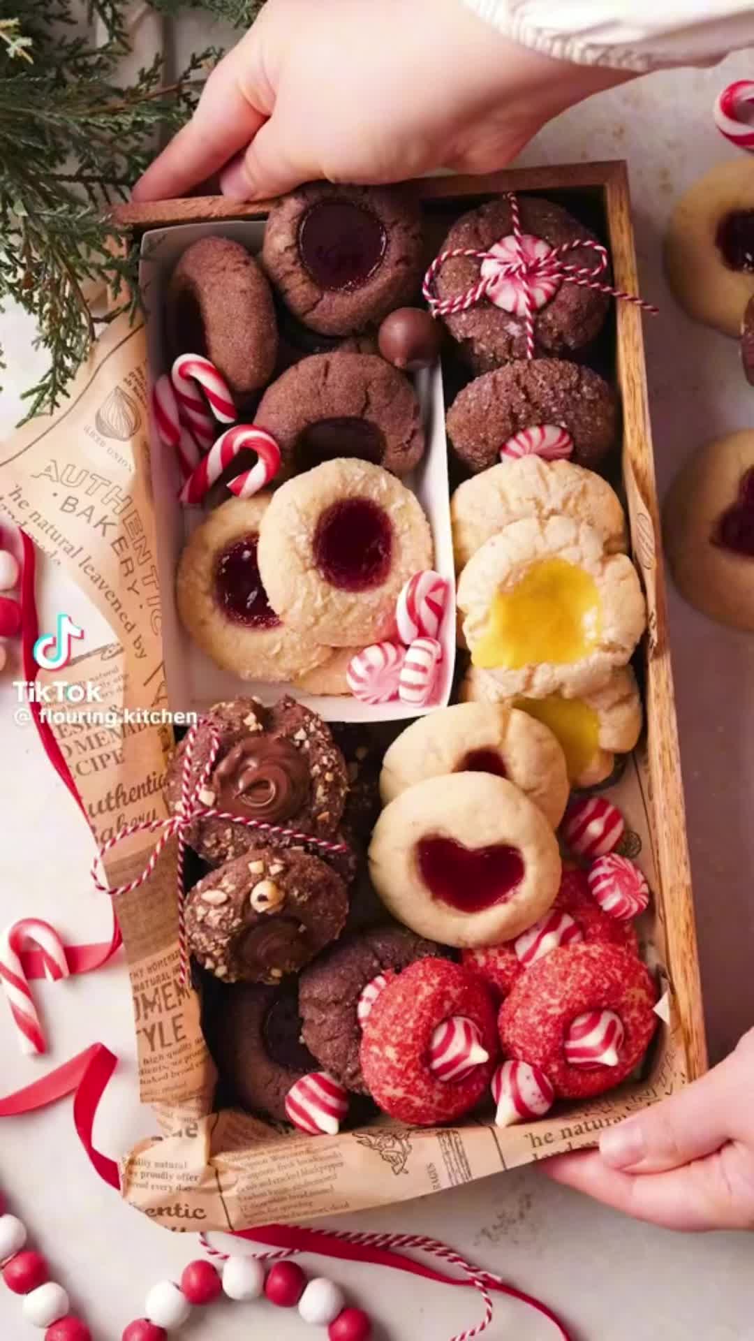 This may contain: a box filled with lots of different types of cookies and pastries on top of a table