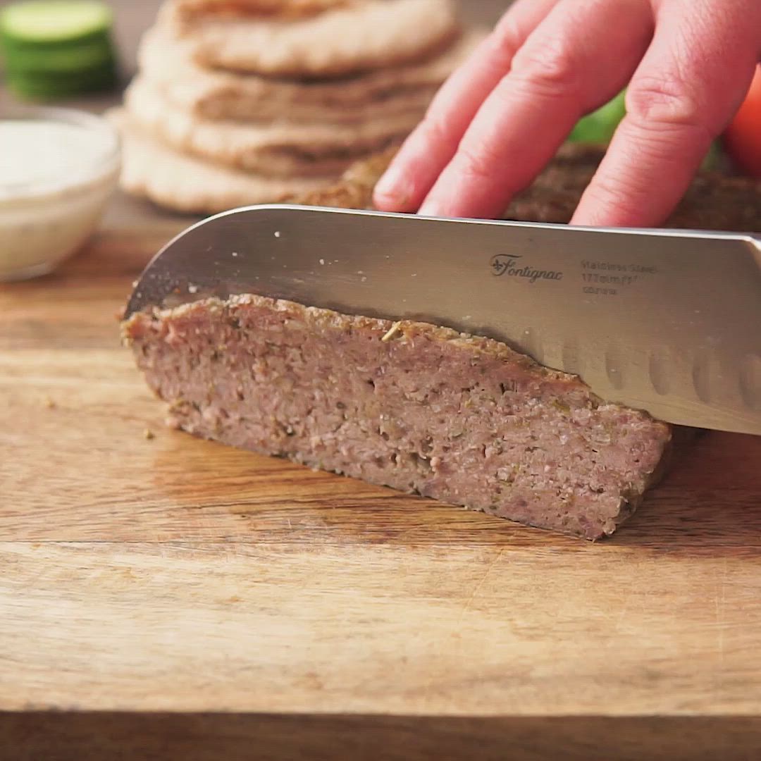 This may contain: a person is cutting meat with a knife