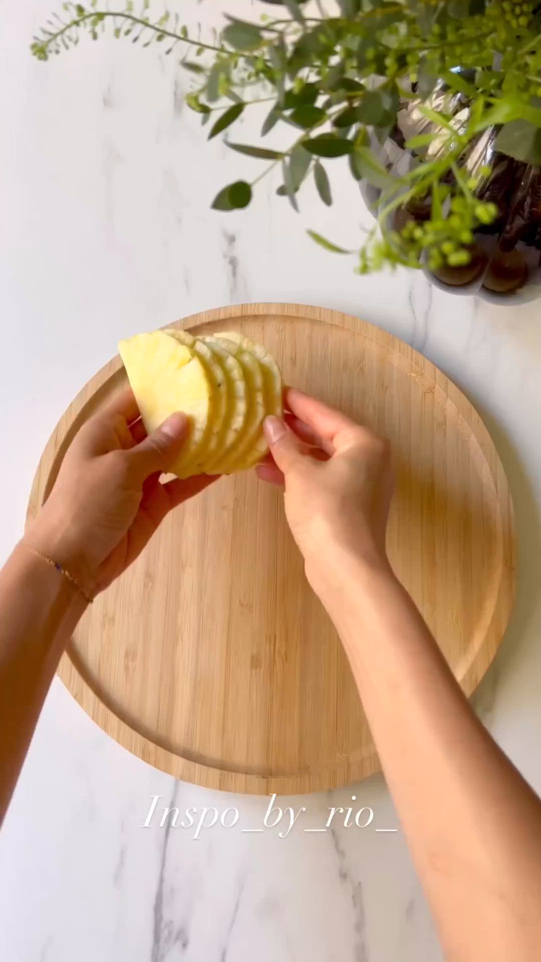 This may contain: a person is peeling an apple on a cutting board