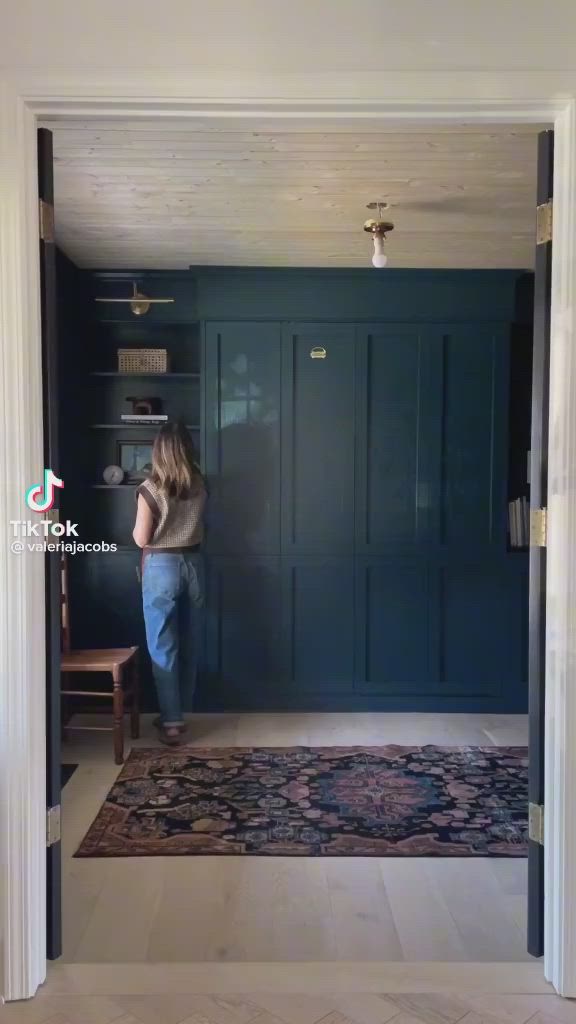 This may contain: a woman standing in front of a blue door