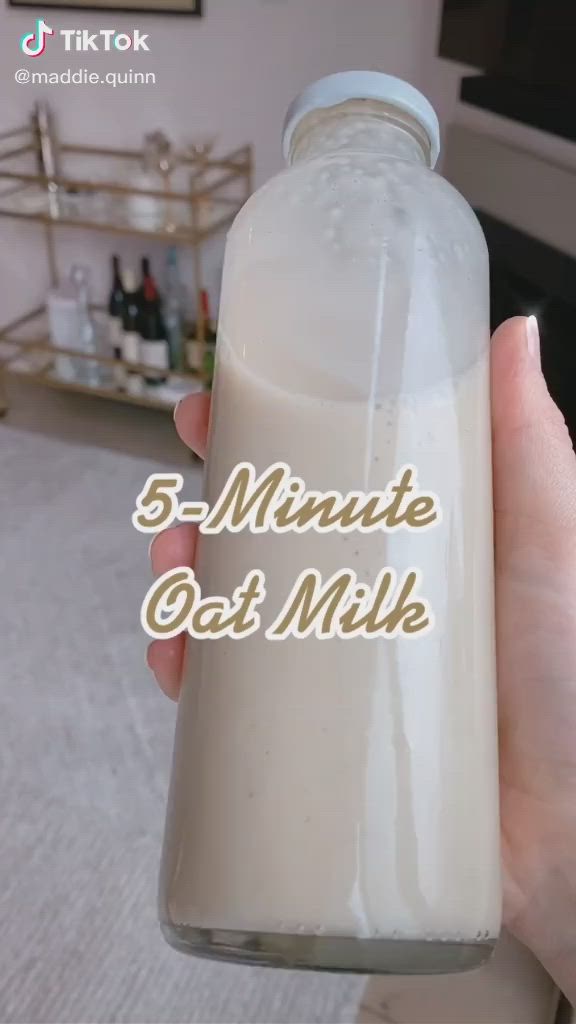 This may contain: a hand holding a bottle of milk with the words 5 minute get milk on it